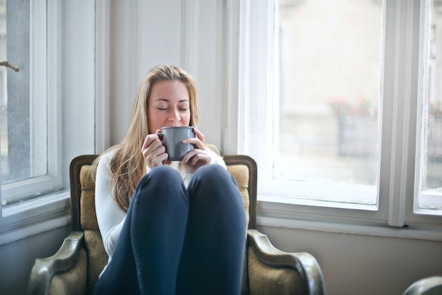 tenant sitting in an arm chair sipping on some coffee